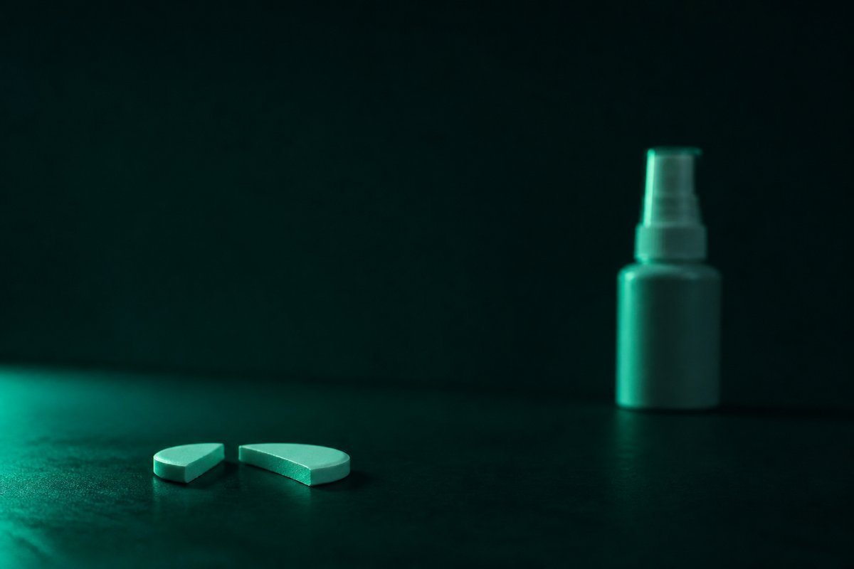 Forest-green still life: broken circle of two days and a nitrate spray set far away