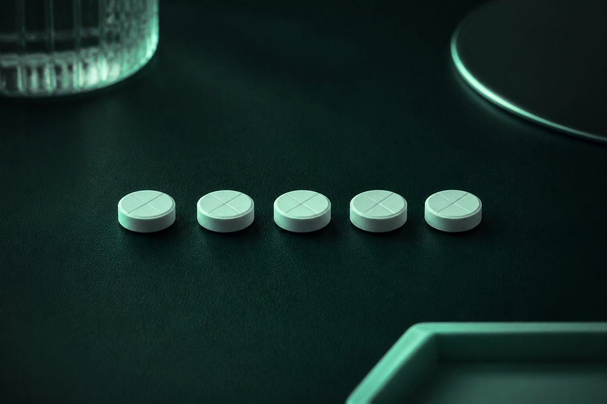 Forest-green still life: five-day row of tablets