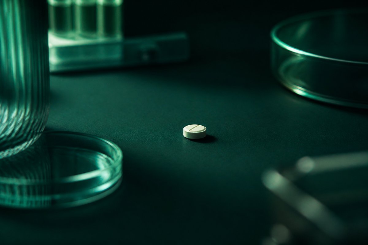 Forest-green still life: tablet with or without a crumb, same place