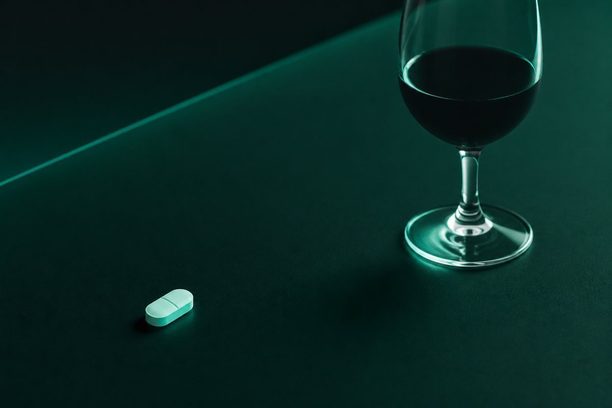 Forest-green still life: wine far from a steroid tablet