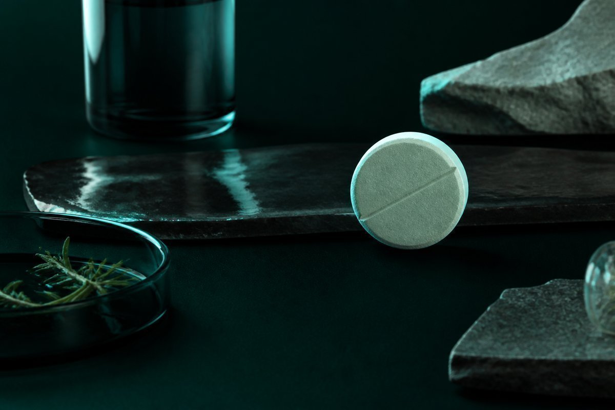Forest-green still life: tiny repeat gap, large tablet held back