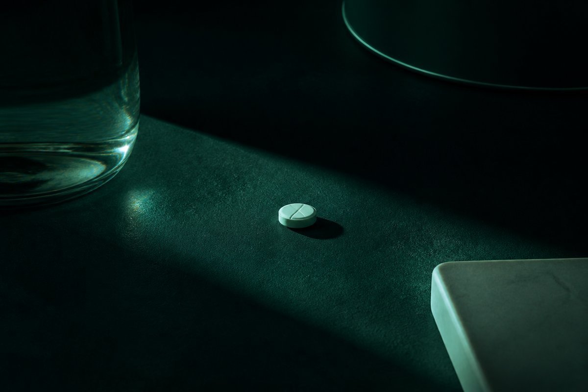 Forest-green still life: morning slot with one small tablet