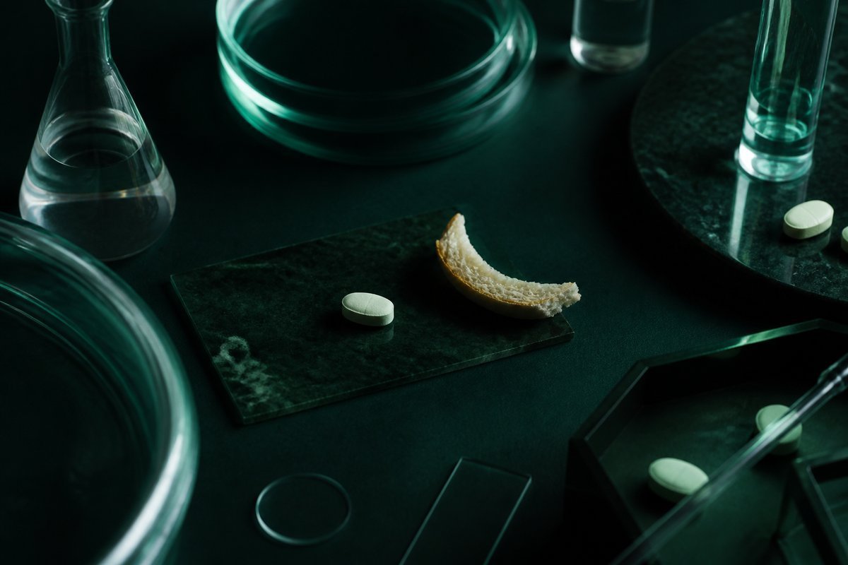Forest-green still life: tablet with and without a bread crust, same place
