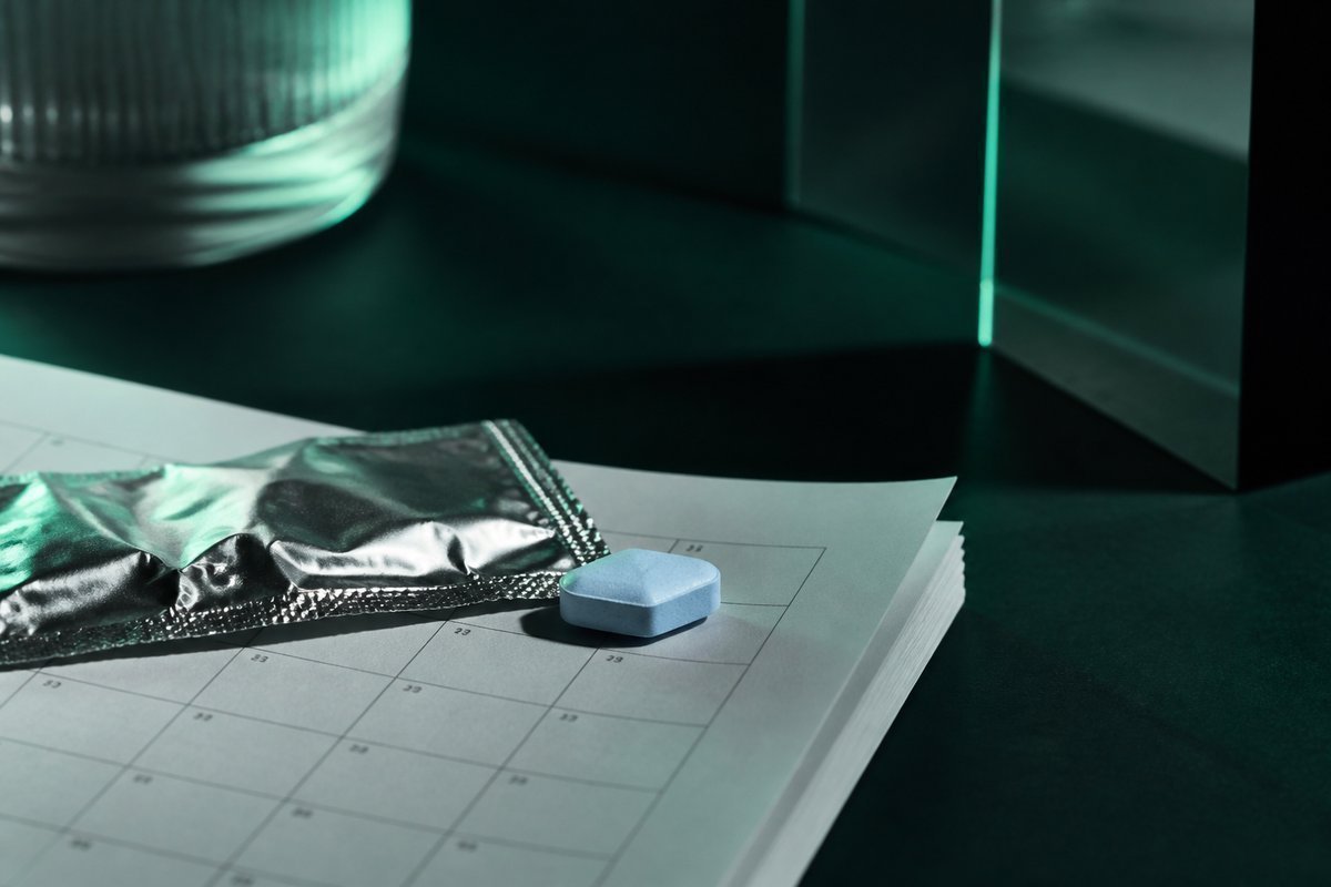 Forest-green still life: calendar leaf and a blue diamond tablet out of foil