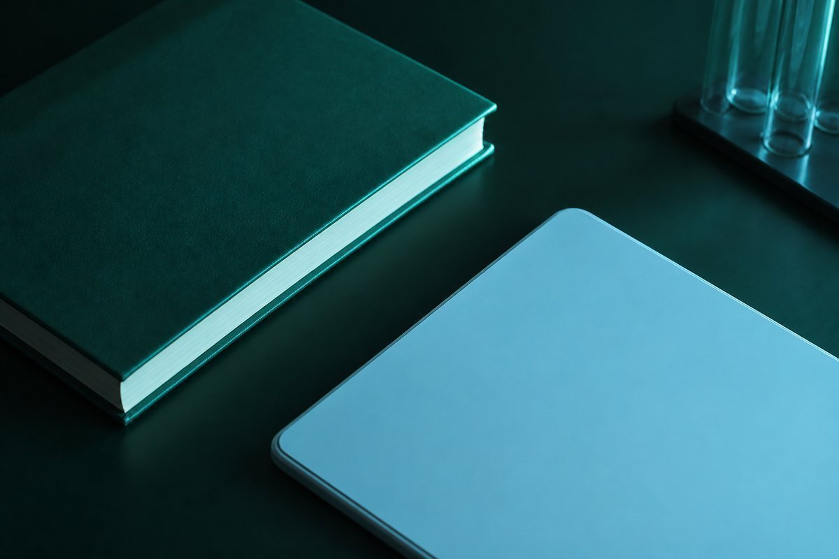 Forest-green still life: closed book and a blue tablet; nothing started